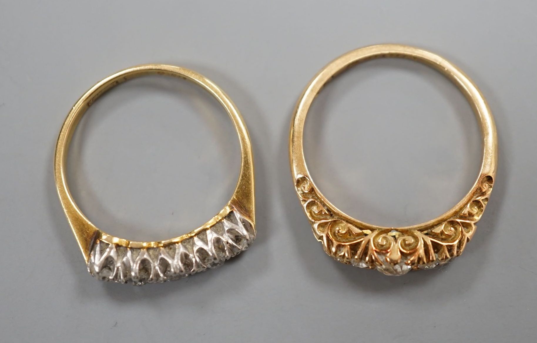 Two early 20th century 18ct and graduated five stone diamond set half hoop rings, gross 5.9 grams.